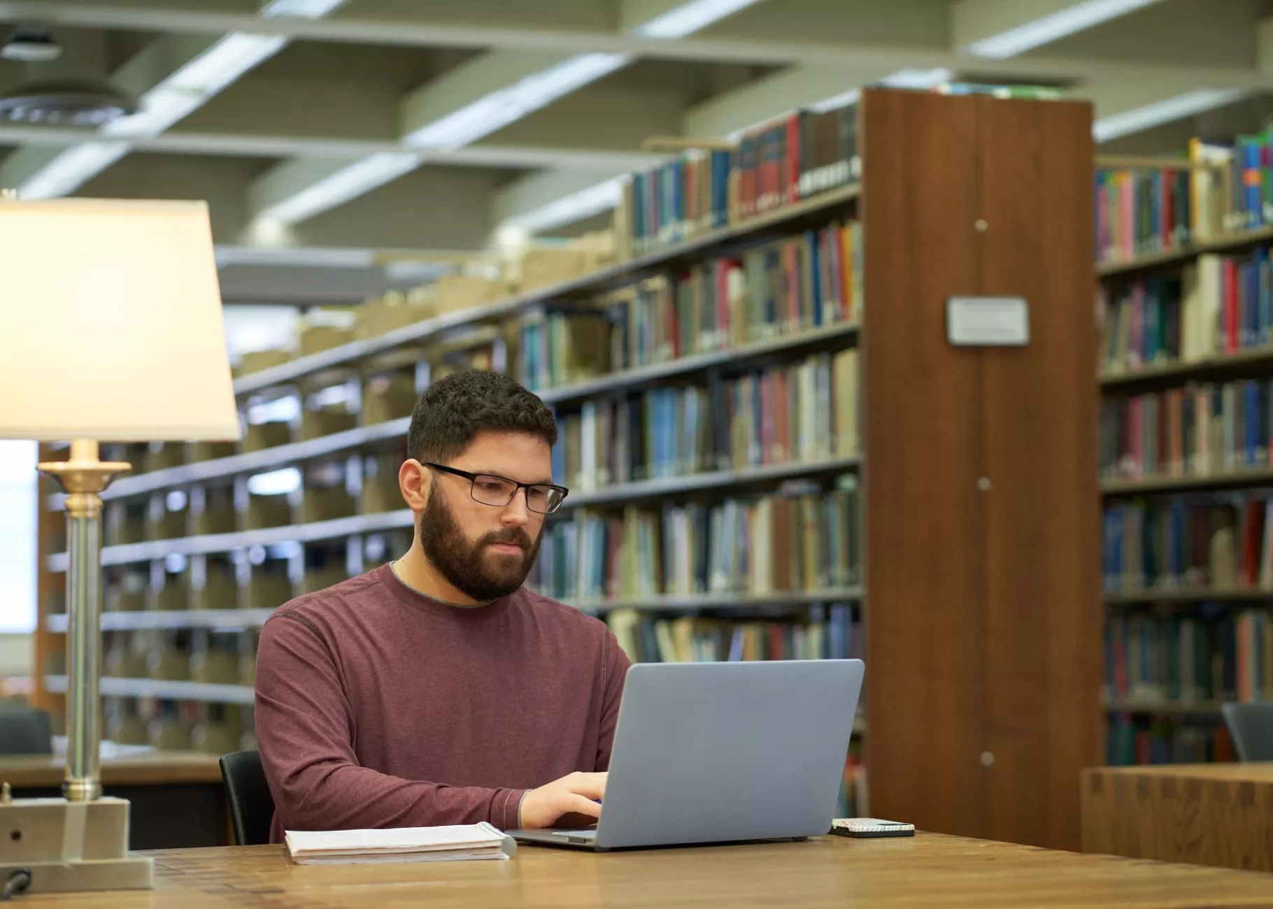 Student studies in the library.