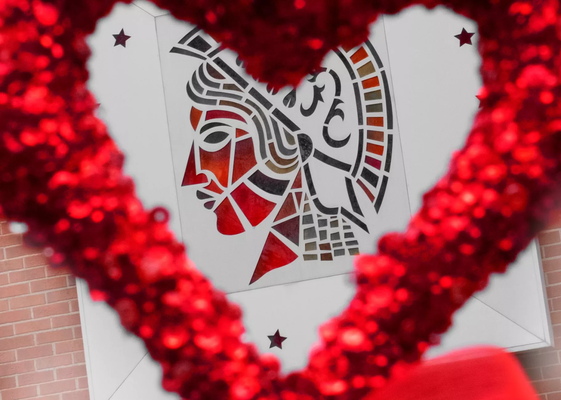 Minerva on the side of Schneider Hall shot through a decorative heart