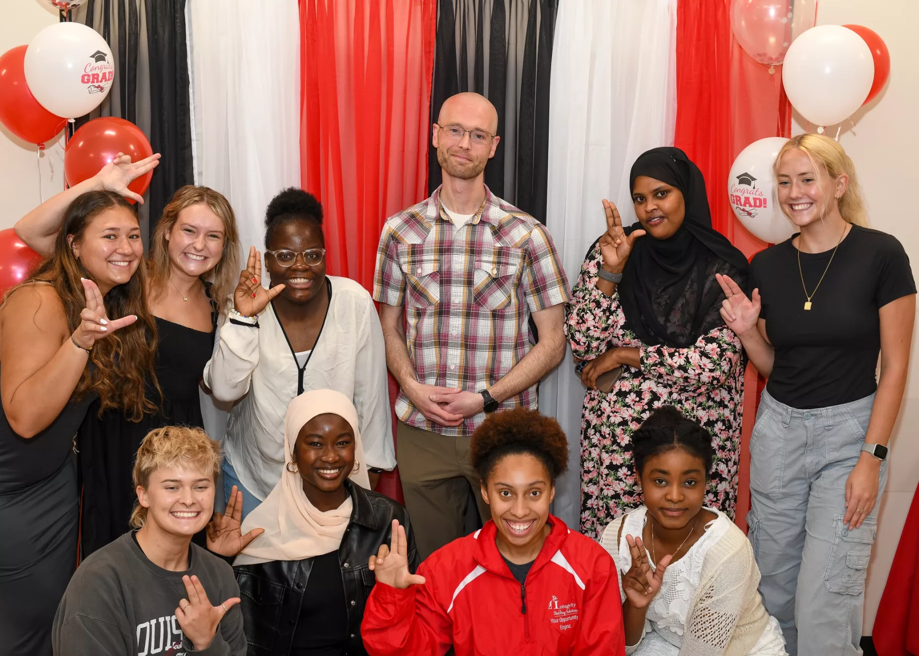 SPHIS Student Graduation Celebration with students holding L's Up