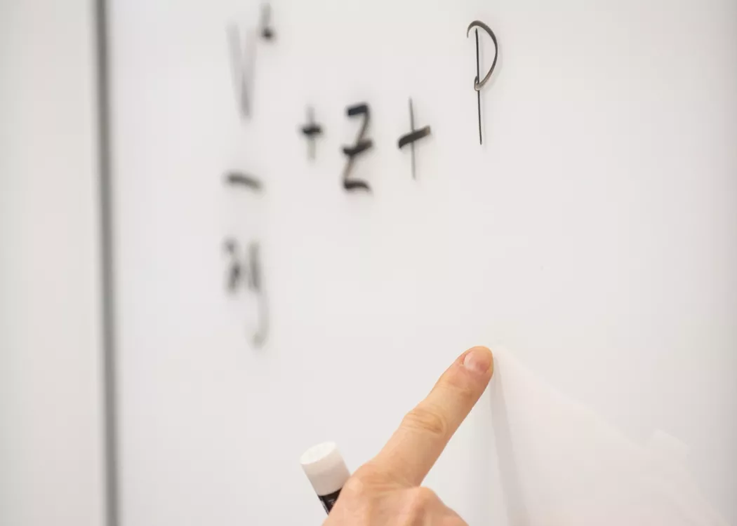 Up close image of math problems on a white board