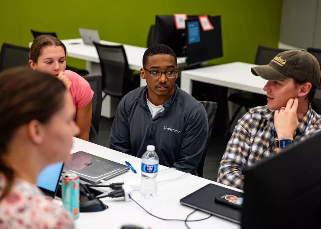 Students in a lecture in the School of Medicine, working in tables and interacting