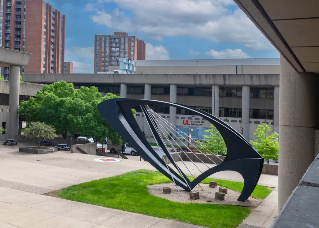 View of the School of Dentistry from Kornhauser Library, with the Ad Astra Sculpture in the foreground